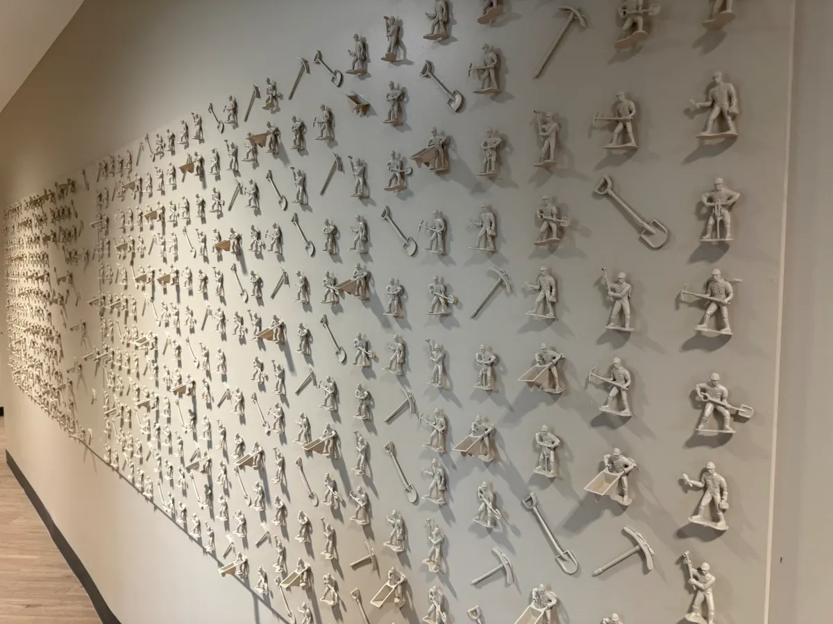 Accent wall covered in mini construction workers and tools at Redeemers Structural Solutions.
